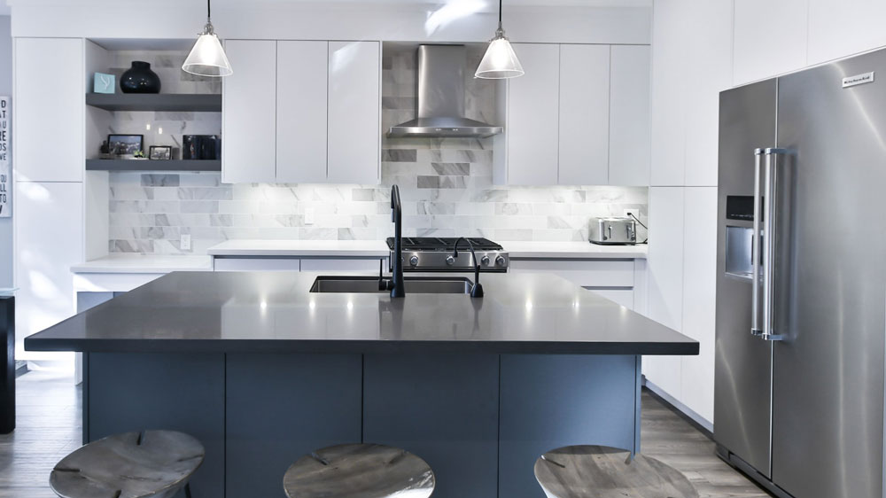 A kitchen with a large stainless steel KitchenAid refrigerator